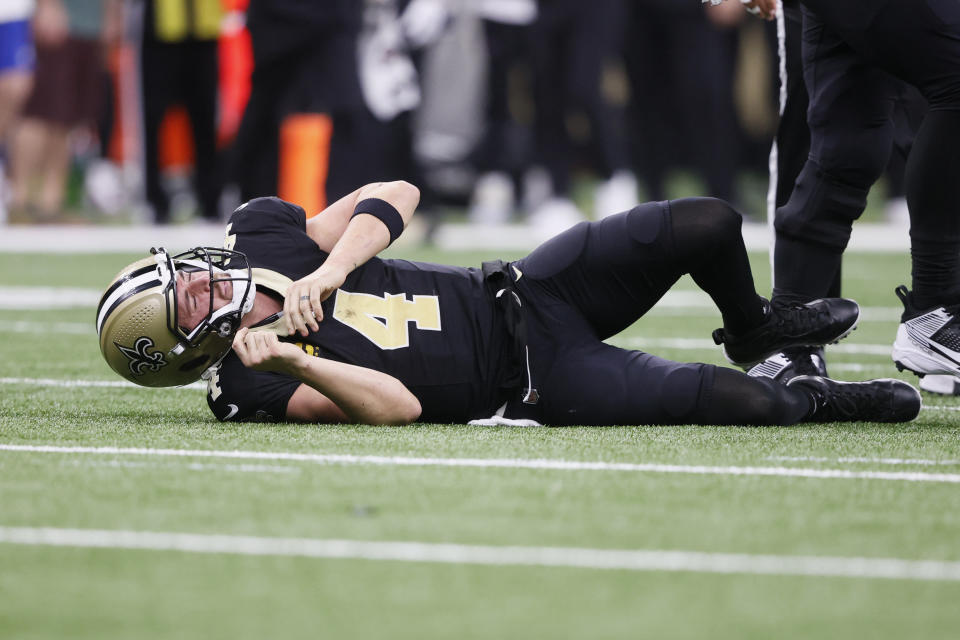New Orleans Saints quarterback Derek Carr (4) on his back after being tackled during the second half of an NFL football game against the Detroit Lions, Sunday, Dec. 3, 2023, in New Orleans. (AP Photo/Butch Dill)