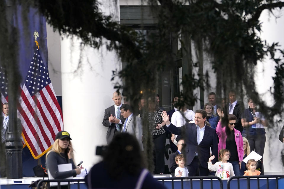 Florida Gov. Ron DeSantis, left, waves with his wife Casey and their children Mason, left, Madison, center, and Mamie, right, as he does a run through in preparation for his inauguration in Monday, Jan. 2, 2023, at the Old Capitol, in Tallahassee, Fla. DeSantis will be sworn in for his second term as Florida Governor Tuesday. (AP Photo/Lynne Sladky)