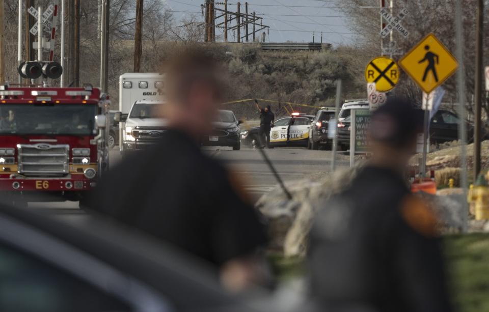 Salt Lake City police work at the scene after shots were fired following a carjacking on Orange Street near 200 South in Salt Lake City on Saturday, March 26, 2022. | Mengshin Lin, Deseret News