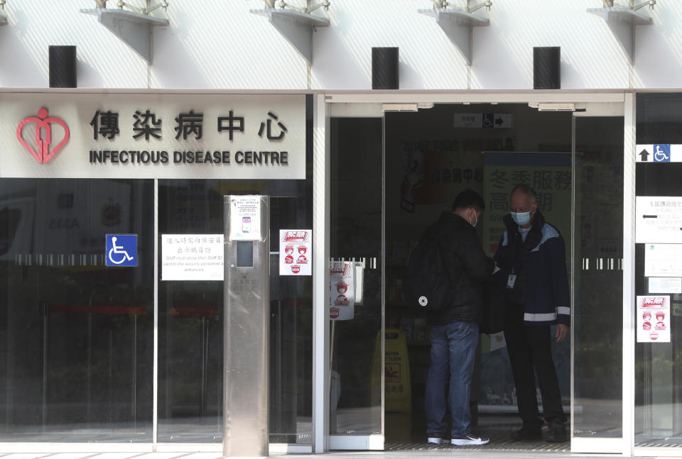 Security check a man inside the infectious disease centre at the Princess Margaret Hospital in Hong Kong, Saturday, Feb, 1, 2020. China’s death toll from a new virus continues to rise as a World Health Organization official says other governments need to prepare for“domestic outbreak control” if the disease spreads. (AP Photo/Achmad Ibrahim)