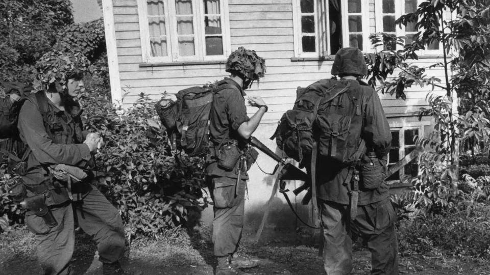 Soldiers with B Company, 2nd Battalion, 505th Parachute Infantry Regiment check a house near Pearls Airport in Grenada in November 1983. (The Fayetteville Observer)