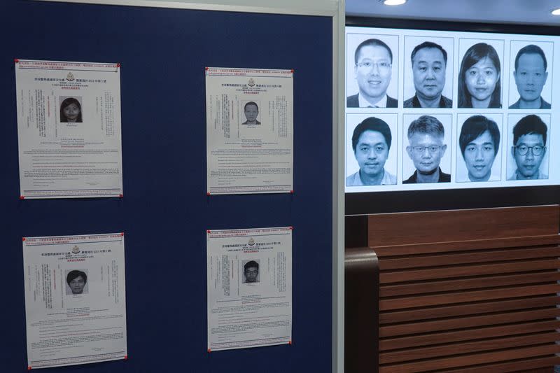 Photos of eight activists who have been issued arrest warrants over national security are displayed during a press conference in Hong Kong