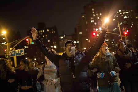 Protesters shout slogans during a demonstration demanding justice for the death of Eric Garner in Manhattan, New York City, December 5, 2014. REUTERS/Eric Thayer