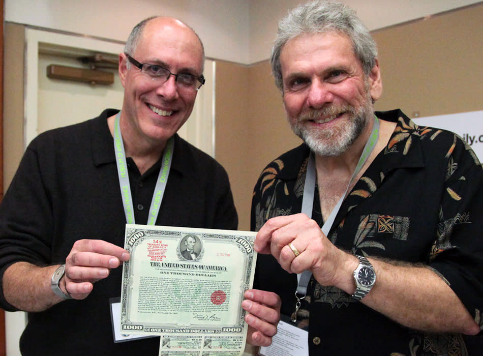 Collector Larry Schuffman and Bob Kerstain hold up a United States One Thousand Dollars 14% Treasury bond.<br><br><a href="http://Scripophily.com" rel="nofollow noopener" target="_blank" data-ylk="slk:Scripophily.com>;elm:context_link;itc:0;sec:content-canvas" class="link ">Scripophily.com></a>