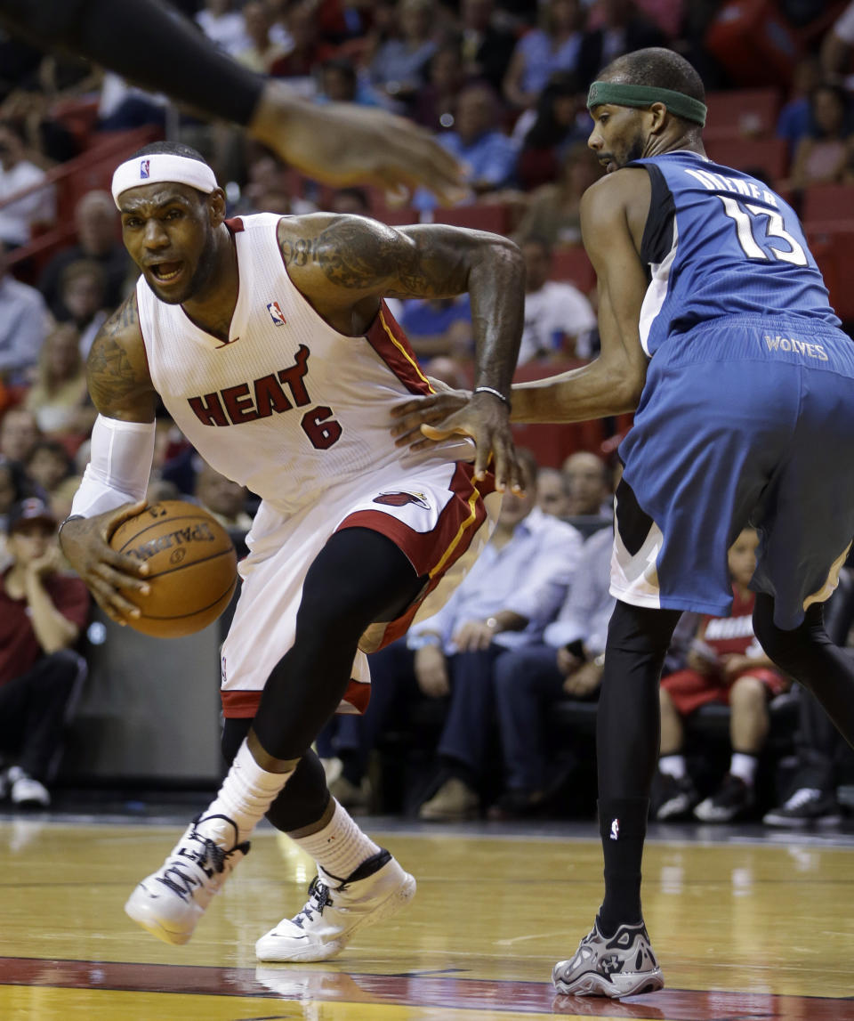 Miami Heat forward LeBron James (6) drives around Minnesota Timberwolves forward Corey Brewer (13) during the first half of an NBA basketball game in Miami, Friday, April 4, 2014. (AP Photo/Alan Diaz)