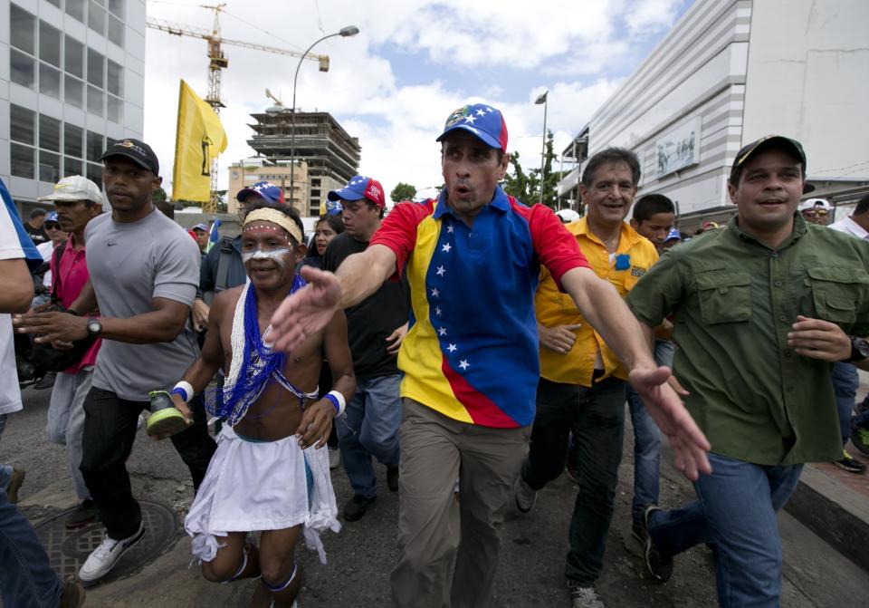 FILE - In this Sept 1, 2016 file photo, Venezuelan opposition leader Henrique Capriles takes part in the "taking of Caracas" march in Caracas, Venezuela. Capriles said Friday, April 7, 2017, that a government agency has banned him from seeking office for 15 years. (AP Photo/Ariana Cubillos, File)