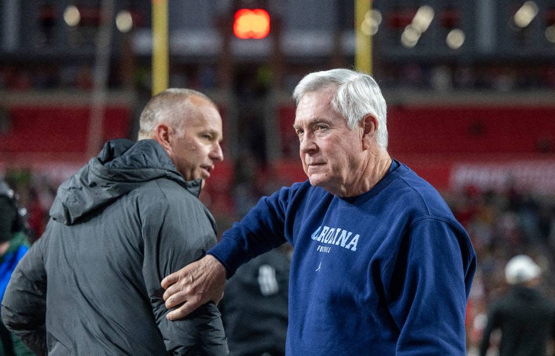 North Carolina coach Mack Brown and N.C. State coach Dave Doeren go their separate ways after a pre-game discussion prior to their game on Saturday, November 25, 2023 at Carter-Finley Stadium in Raleigh, N.C.