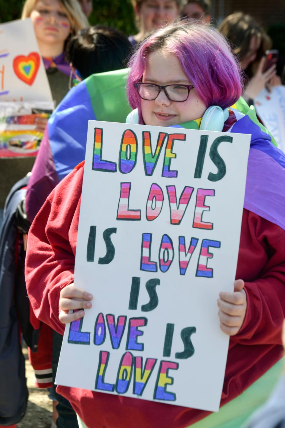 Fort Walton Beach High School student Sierra Kegan holds a sign protesting the Florida Legislature's "Don't Say Gay" bill during a protest after school Monday.