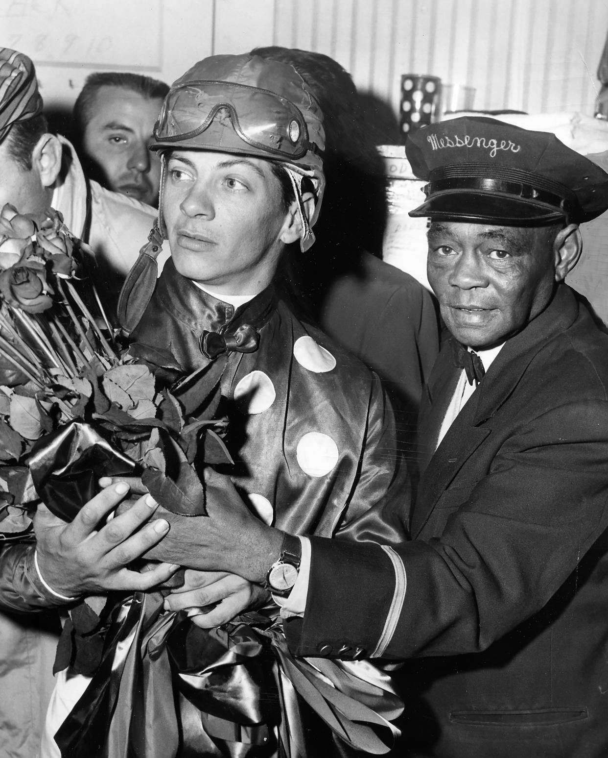 Jockey Bill Hartack holds the roses he and Iron Liege won by beating out Gallant Man in the 1957 Kentucky Derby at Churchill Downs.
May 4, 1957