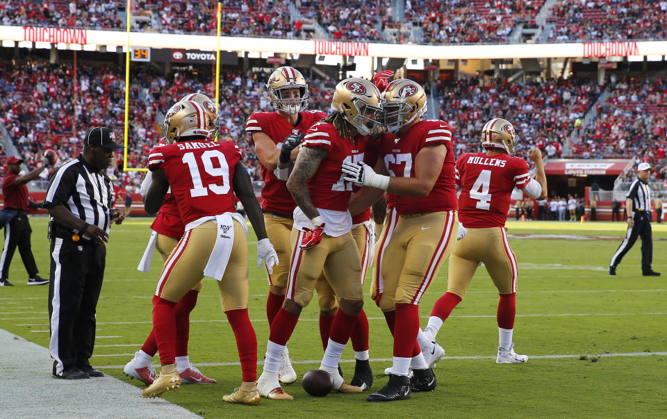San Francisco 49ers wide receiver Jalen Hurd, center, celebrates with teammates after scoring against the Dallas Cowboys during the first half of an NFL preseason football game in Santa Clara, Calif., Saturday, Aug. 10, 2019. (AP Photo/John Hefti)