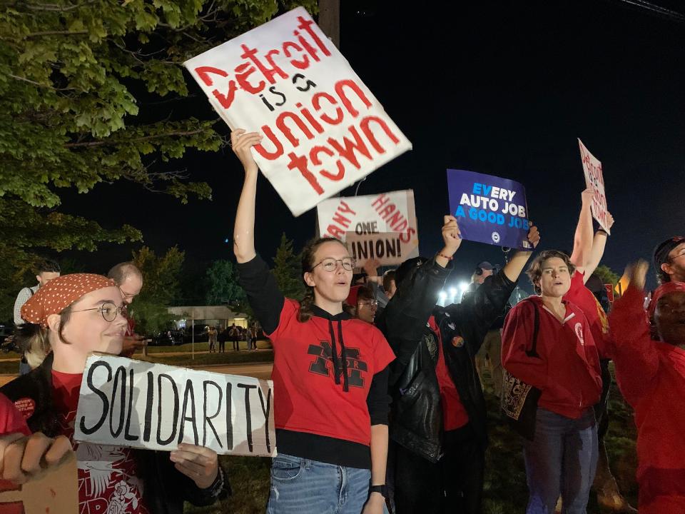 Tess Mello, 23, of Ann Arbor, and a member of the Graduate Employees' Organization at the University of Michigan, center, stands with other UAW supporters across from the Ford Michigan Assembly plant in Wayne less than an hour ahead of an impending UAW strike Thursday night, September 14, 2023.