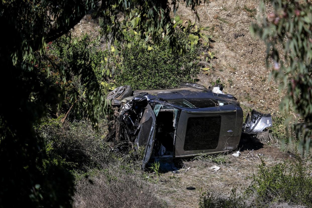 A vehicle rests on its side after a rollover accident involving golfer Tiger Woods along a road in the Rancho Palos Verdes suburb of Los Angeles on Tuesday, Feb. 23, 2021.