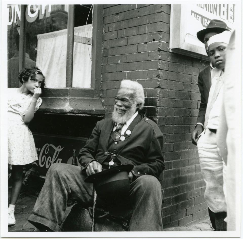 A gentleman sits out a store in Wilmington Delaware during the Big Quarterly of 1939.