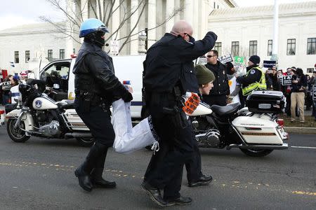 U.S. Capitol Police arrest pro-choice protesters for blocking the way of the anti-abortion March for Life at the U.S. Supreme Court building in Washington January 22, 2015. REUTERS/Jonathan Ernst