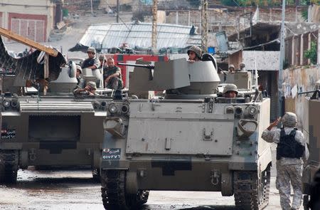 Lebanese army soldiers patrol the Sunni Muslim Bab al-Tebbaneh neighbourhood after being deployed to tighten security, following clashes between Lebanese soldiers and Islamist gunmen, October 27, 2014. REUTERS/Stringer