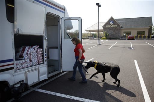 Paula Hackett, of Harleysville, Pa., leads her dog Tosey, a 5-year-old Great Dane, into the University of Pennsylvania veterinary school's animal bloodmobile in Harleysville, Pa. 
