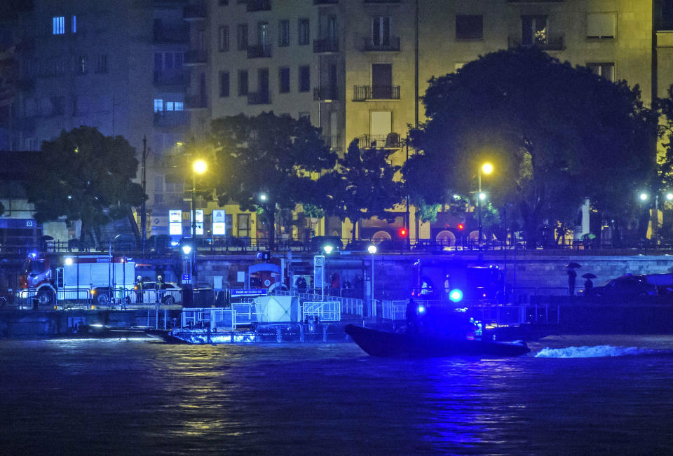 FILE - In this Wednesday, May 29, 2019 file photo, a rescue boat searches for victims late after a tourist boat crashed with a river cruise boat, in River Danube in Budapest. Hungarian police say that the deceased captain of the tour boat which sank after colliding with a river cruise ship on the Danube River was not to blame for the deadly incident. Twenty-eight people, mostly South Korean tourists, aboard the Hableany (Mermaid) sightseeing boat died after their vessel collided with the Viking Sigyn river cruise ship on May 29, 2019. The remains of a South Korean tourist have yet to be recovered. (Peter Lakatos/MTI via AP, file)