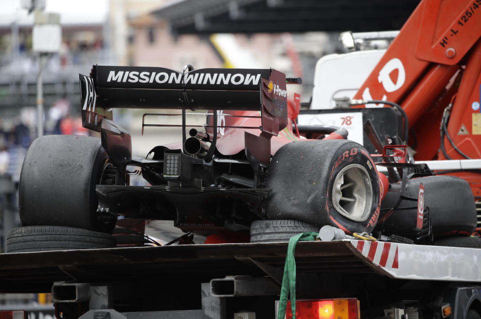 The car of Ferrari driver Charles Leclerc of Monaco is taken off the track after a crash during the qualifying session at the Monaco racetrack, in Monaco, Saturday, May 22, 2021. The Formula One race will take place on Sunday with Ferrari driver Charles Leclerc of Monaco in pole position. (AP Photo/Luca Bruno)