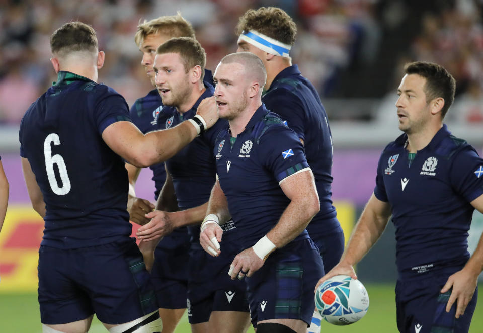 Scotland's Finn Russell is congratulated by teammates after scoring his team's first try during the Rugby World Cup Pool A game at International Stadium between Japan and Scotland in Yokohama, Japan, Sunday, Oct. 13, 2019. (AP Photo/Christophe Ena)