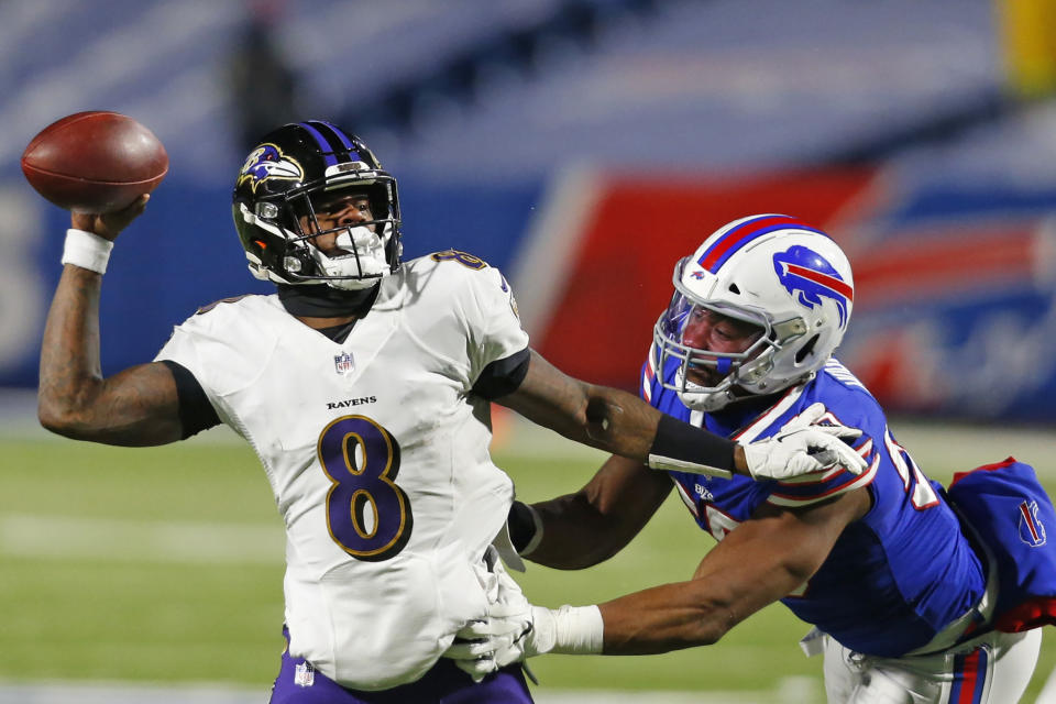 Buffalo Bills defensive end Jerry Hughes (55) pressures Baltimore Ravens quarterback Lamar Jackson (8) during the second half of an NFL divisional round football game Saturday, Jan. 16, 2021, in Orchard Park, N.Y. (AP Photo/Jeffrey T. Barnes)