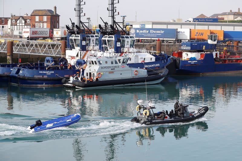 An inflatable boat used by migrants is brought by Border Forces crew at Dover harbour, in Dover