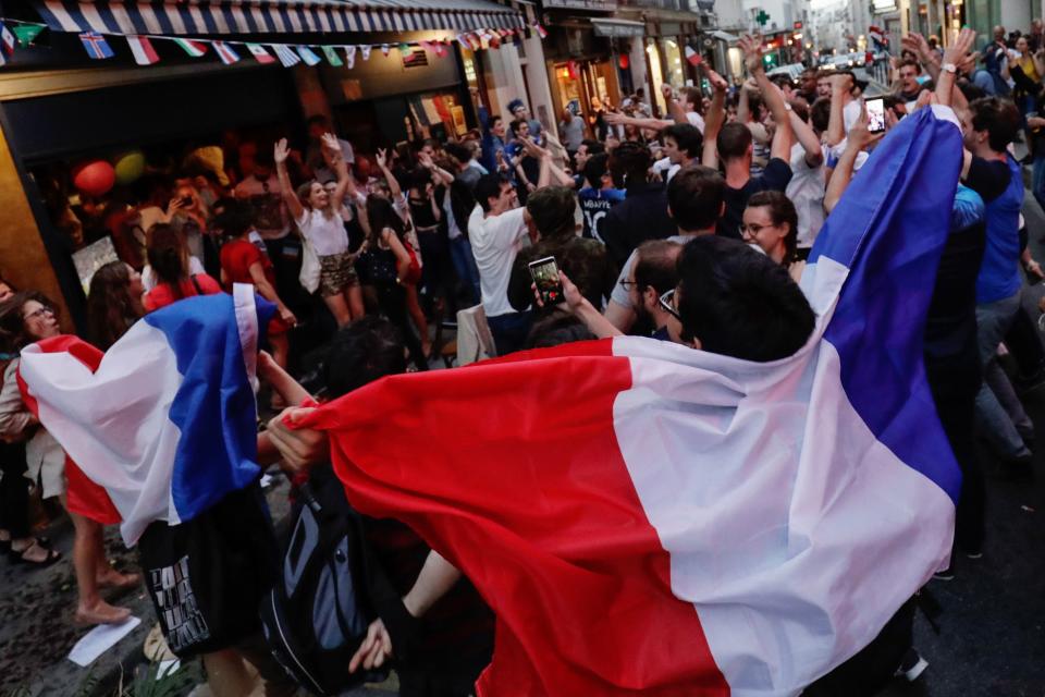 <p>People celebrate France’s victory outside a cafe in central Paris on July 10, 2018 at the final whistle at the Russia 2018 World Cup semi-final football match between France and Belgium. (Photo by Thomas SAMSON / AFP) </p>