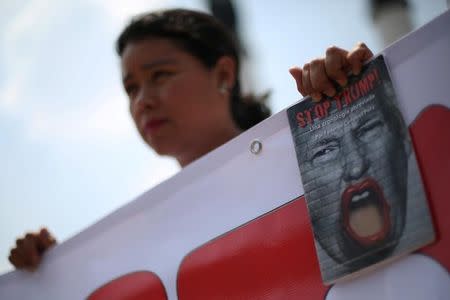 An activist takes part in a demonstration against Republican presidential nominee Donald Trump at Ninos Heroes monument in Mexico City, Mexico, September 13, 2016. REUTERS/Edgard Garrido