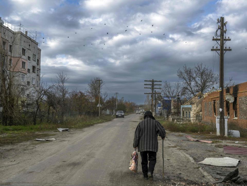 An old woman walks in the Kherson region village of Arkhanhelske on November 3. Russian troops are withdrawing from the Kherson region (AFP via Getty Images)