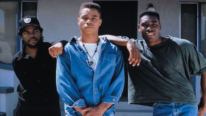 Three African American men stand together and pose.