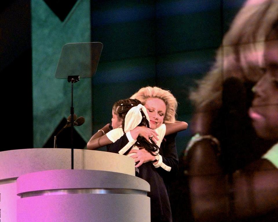 AIDS activist hugs 12 year-old Hydeia Broadbent, who has AIDS, on the podium of the GOP convention Monday after the girl talked about her ailment.