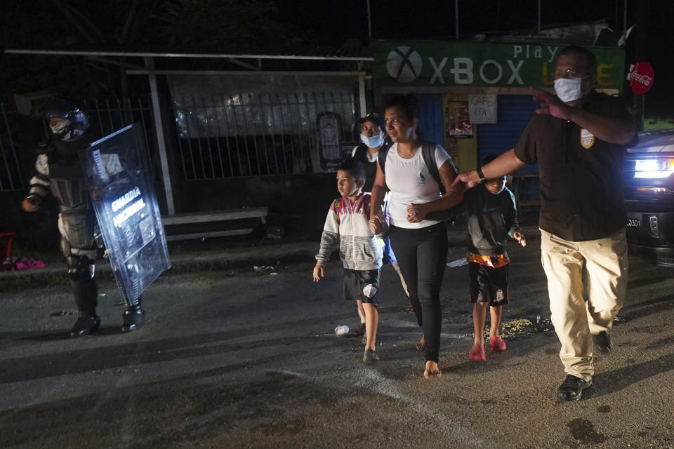 Mexican immigration agents detain Central American migrants who are part of a caravan heading north in Huixtla, Chiapas state, Mexico, Sunday, Sept. 5, 2021. (AP Photo/Marco Ugarte)