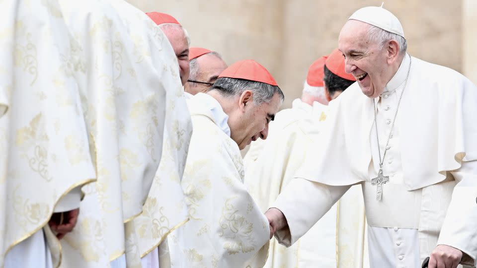 Pope Francis, right, and Cardinal Giovanni Angelo Becciu, center, are seen during the canonization mass of two new saints in St. Peter's Square, Vatican City, on October 9, 2022. - Maria Laura Antonelli/Shutterstock