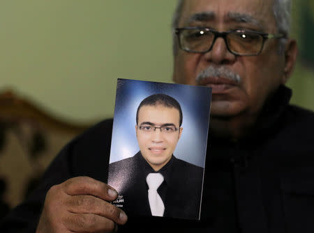 Reda Abdullah al-Hamamy, the father of Abdullah Reda al-Hamamy who is suspected of attacking a soldier in Paris' Louvre museum, holds a picture of his son during an interview with Reuters in Daqahliya, Egypt, February 4, 2017. REUTERS/Mohamed Abd El Ghany