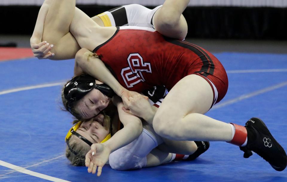 De Pere’s Brooke Corrigan, top, is a two-time state champion and among the top 25 girls wrestlers to watch this season in Wisconsin.