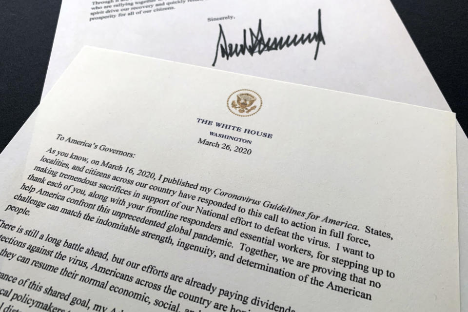 A letter from President Donald Trump to the nation's governors is photographed Thursday, March 26, 2020. Trump says that federal officials are developing guidelines to rate counties by risk of virus spread and that he wants to begin easing nationwide guidelines meant to stem the coronavirus outbreak. In the letter, Trump says the new guidelines are meant to enable state and local leaders to make "decisions about maintaining, increasing, or relaxing social distancing and other measures they have put in place." (AP Photo/Jon Elswick)