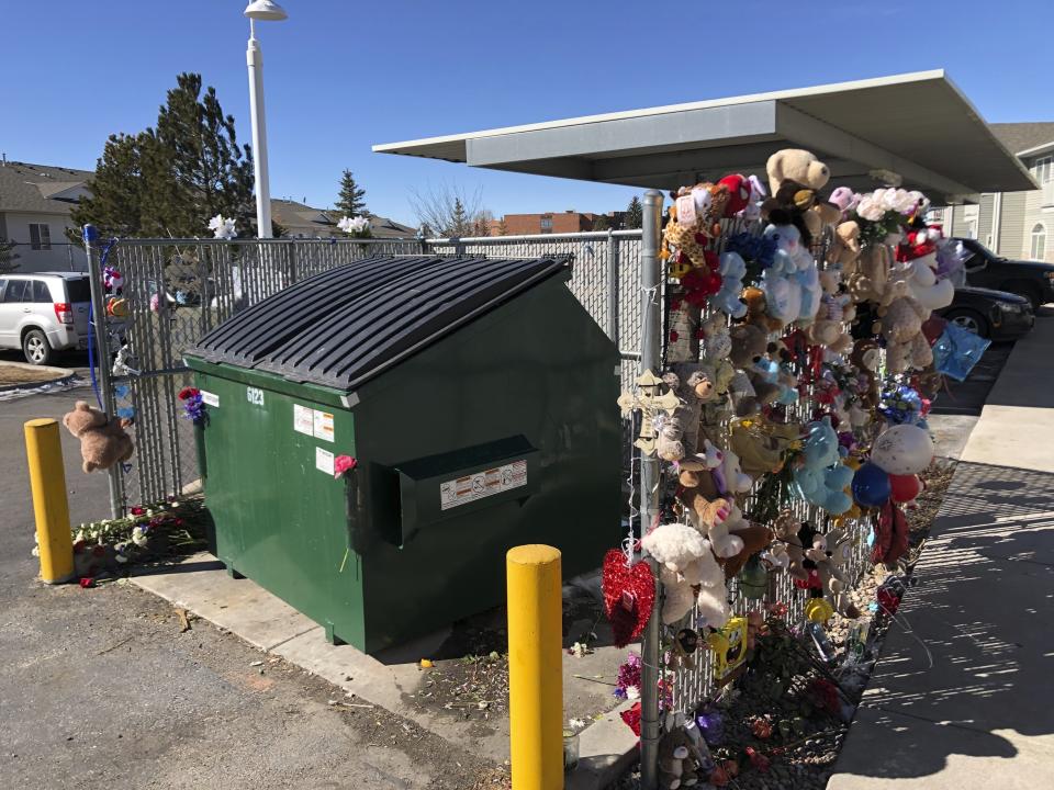 FILE - In this Feb. 22, 2021, file photo, stuffed animals and notes of condolences are seen attached to a fence around a dumpster at a Cheyenne, Wyo., apartment complex where a 2-year-old boy was found dead. Prosecutors have charged a Cheyenne man in the death of the boy whose body was found in the dumpster. Wyatt Dean Lamb faces one count of first-degree murder and 10 counts of child abuse for the death of Athian Rivera, according to charging documents filed Monday, June 28, 2021. (AP Photo/Mead Gruver,File)