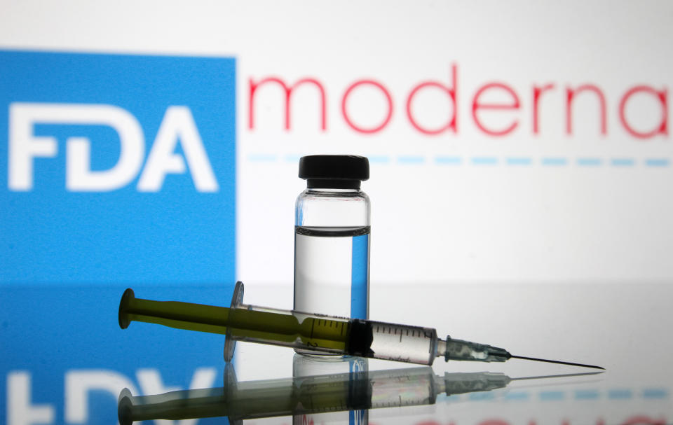 UKRAINE - 2020/12/15: In this photo illustration, a vial and a medical syringe seen displayed in front of the Food and Drug Administration (FDA) of the United States and Moderna biotechnology company's logos. FDA finds the COVID-19 vaccine. (Photo Illustration by Pavlo Gonchar/SOPA Images/LightRocket via Getty Images)