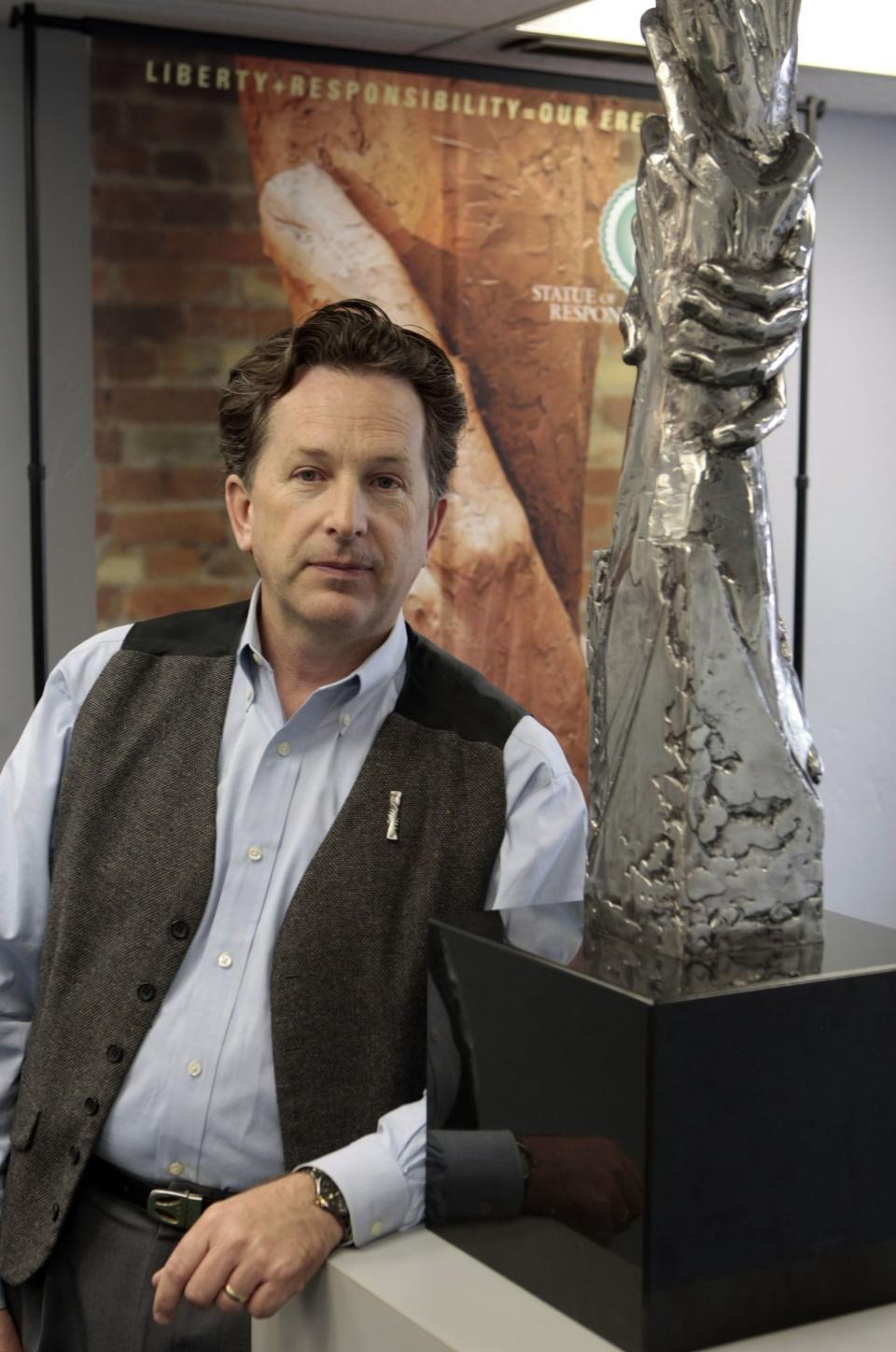 Daniel Bolz stands with a scale-model of his Statue of Responsibility at his office in Spanish Fork on May 15, 2008. Bolz has a goal of building a 300-foot version of the interlocked arms on the West Coast that would bookend the country with the Statue of Liberty. | Jason Olson, Deseret News