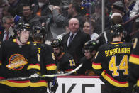 Vancouver Canucks coach Bruce Boudreau stands behind the bench during the third period of the team's NHL hockey game against the Seattle Kraken on Tuesday, April 26, 2022, in Vancouver, British Columbia. (Darryl Dyck/The Canadian Press via AP)