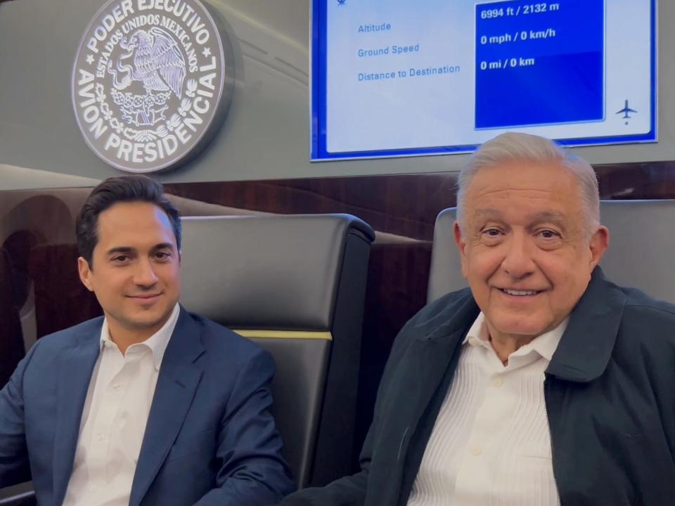 President the Andrés Manuel López Obrador sitting onboard the 787 next to an unnamed official.