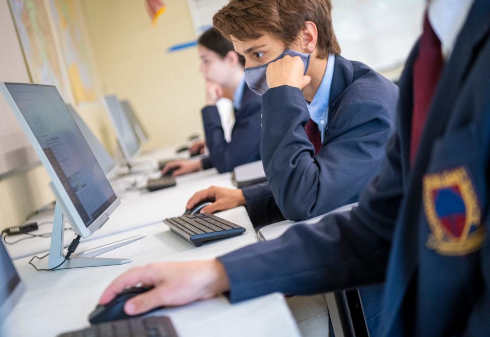 Seven Oaks Classical School student Tyler Neal works on a project with the school’s web design and coding club. The school made the wearing of face masks optional in 2021, despite a county health order calling for the use of masks in indoor public settings.