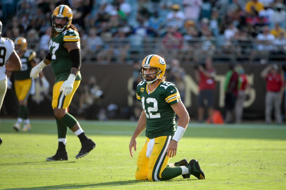 Green Bay Packers quarterback Aaron Rodgers (12) gets up after a play during the second half of an NFL football game against the New Orleans Saints, Sunday, Sept. 12, 2021, in Jacksonville, Fla.