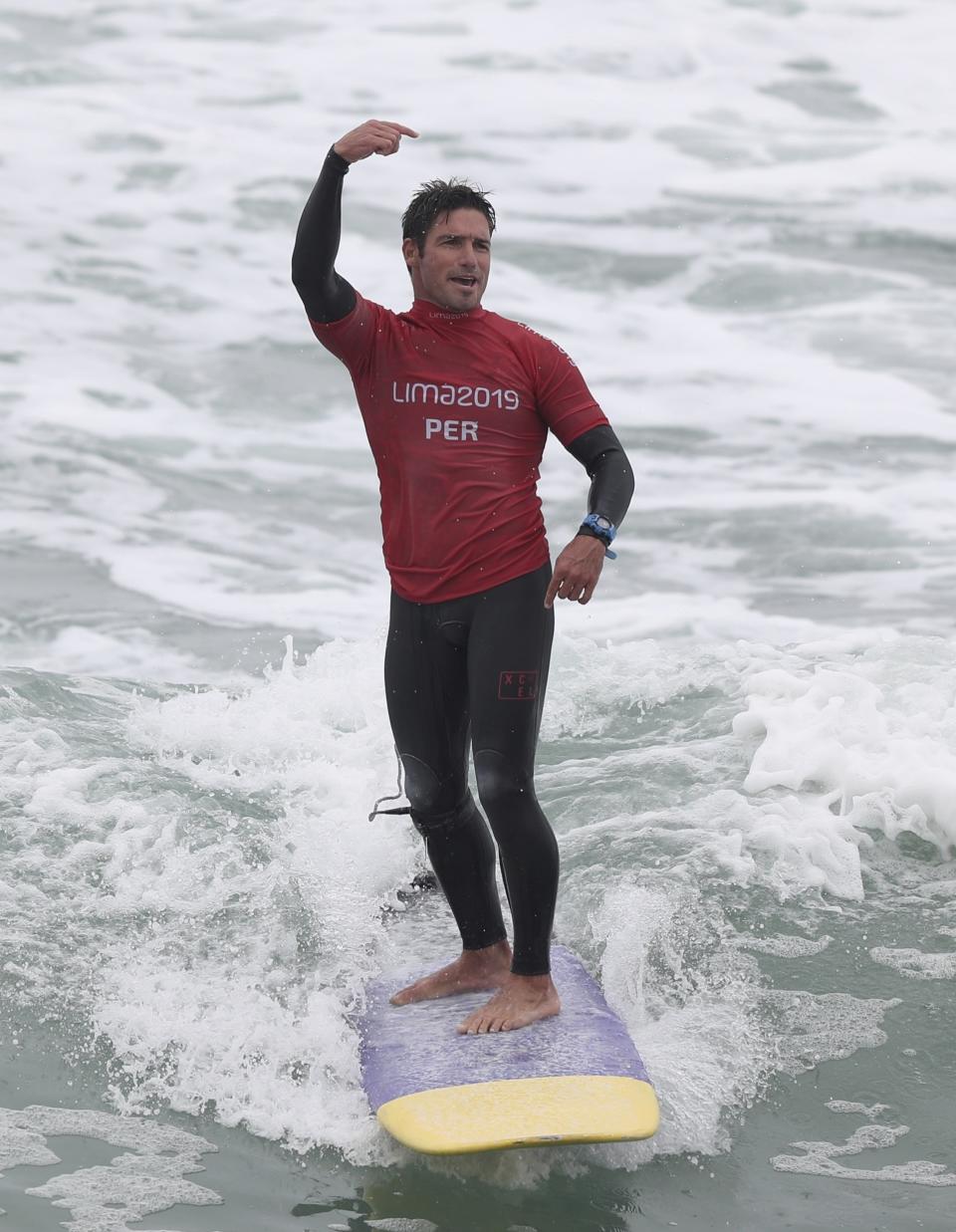 Benoit Clemente of Peru celebrates after winning the gold for longboard during men's SUP surfing a thte Pan American Games on Punta Rocas beach in Lima Peru, Sunday, Aug. 4, 2019. (AP Photo/Martin Mejia)
