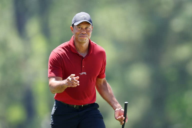 Golf superstar Tiger Woods acknowledges fans while walking to the 18th green during the final round of the 2024 Masters at Augusta National Golf Club (Andrew Redington)