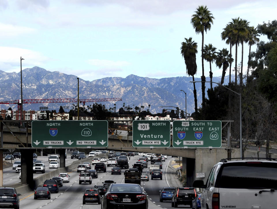 Traffic along the 110 freeway moves along a day before a rain is set to hit in Los Angeles, Wednesday, Jan. 27, 2021. Wide areas of the state remained under warnings and watches for flooding, heavy snow and winds. (Keith Birmingham/The Orange County Register/SCNG via AP)