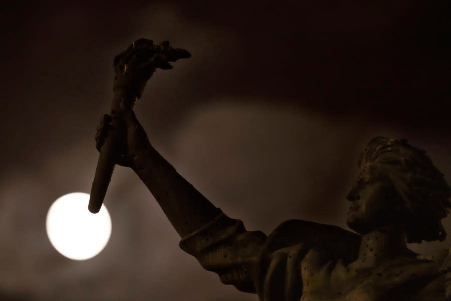 The full moon rises beyond the Martyrs statue, in downtown Beirut, Lebanon, Wednesday, Aug. 30, 2023. August 30 will see the month’s second supermoon, when a full moon appears a little bigger and brighter thanks to its slightly closer position to Earth. (AP Photo/Hussein Malla)