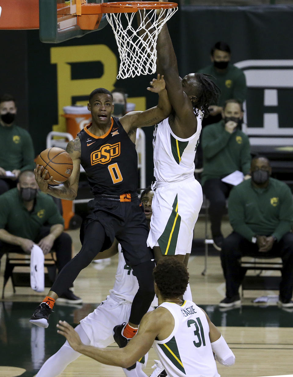 Oklahoma State guard Avery Anderson III (0) attempts a shot past Baylor forward Jonathan Tchamwa Tchatchoua (23) in the first half of an NCAA college basketball game, Thursday, March 4, 2021, in Waco, Texas. (AP Photo/Jerry Larson)