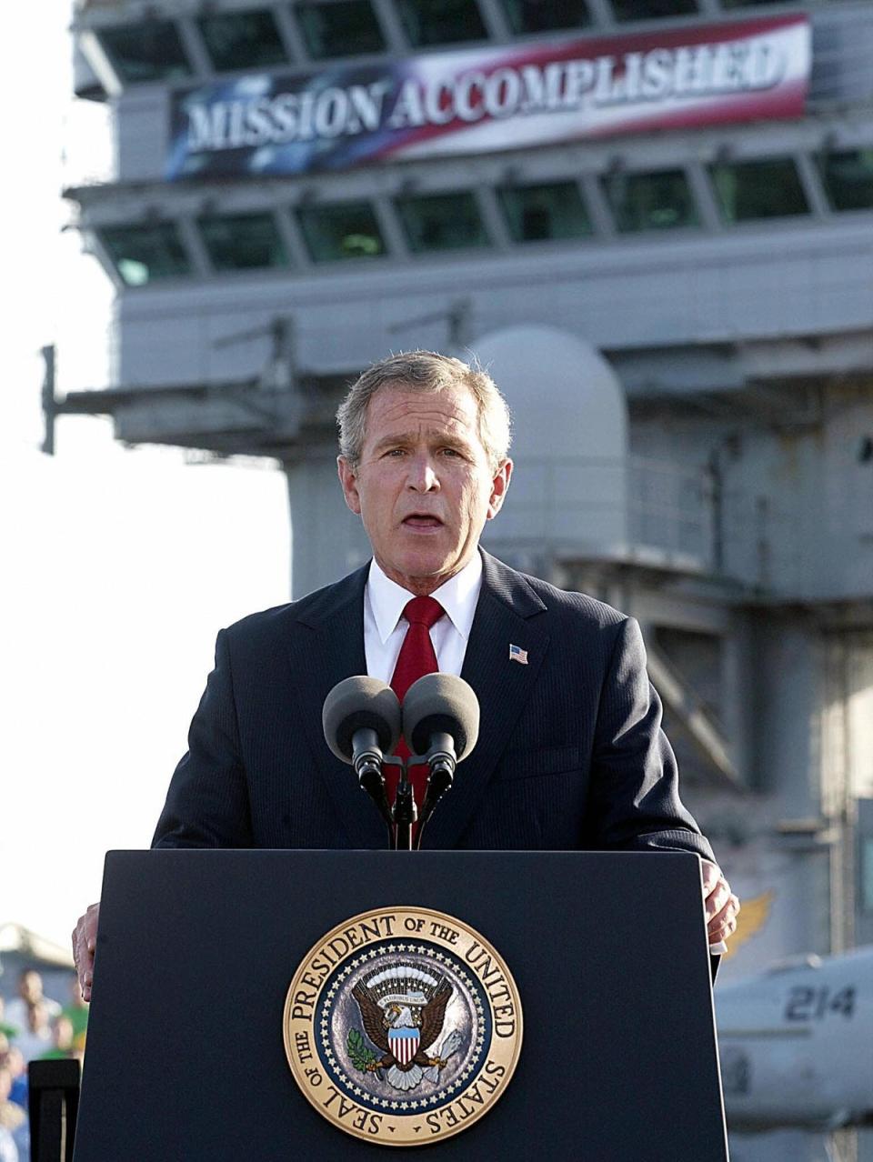 George W Bush aboard aircraft carrier USS Abraham Lincoln in front of a ‘Mission Accomplished’ banner (AFP/Getty)