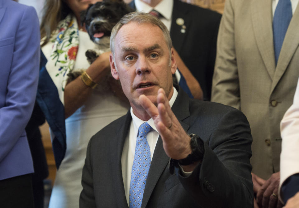 Interior Secretary Ryan Zinke speaks at the Interior Department in Washington, Wednesday, March 29, 2017, after signing an order lifting a moratorium on new coal leases on federal lands and a related order on coal royalties. (AP Photo/Molly Riley)