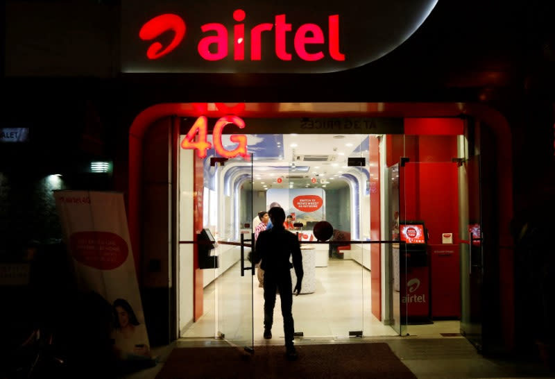 FILE PHOTO: A man leaves a Bharti Airtel store in New Delhi